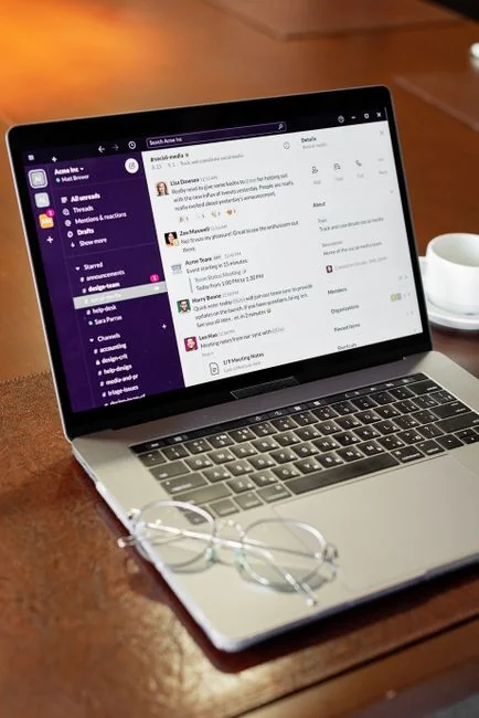 A close-up view of a smartphone screen displaying the email inbox, held by an adults hand.